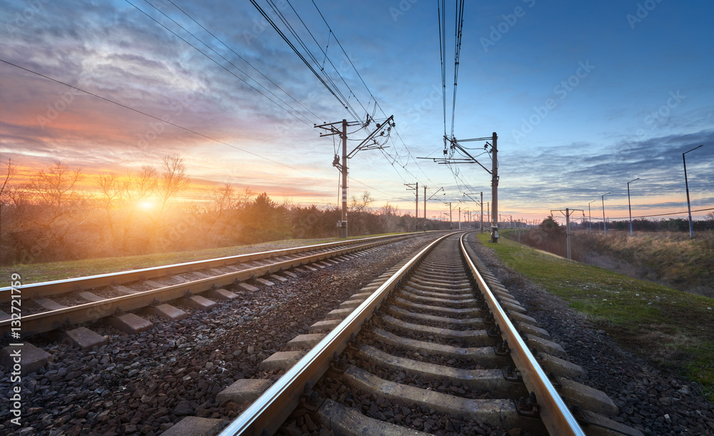 Railway station against beautiful sunny sky. Industrial landscape with railroad, blue sky and colorf