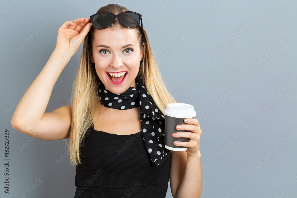 Happy young woman drinking coffee