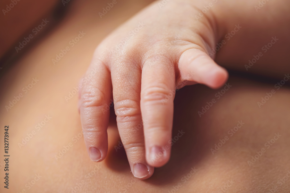 Newborn infant baby boys hand close up