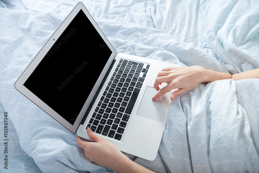 Young girl using laptop at home close up