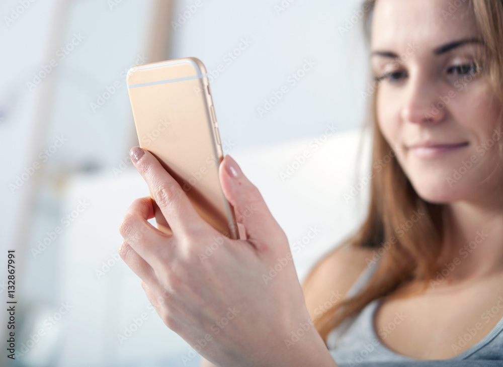 Young girl checking her smart phone, close up