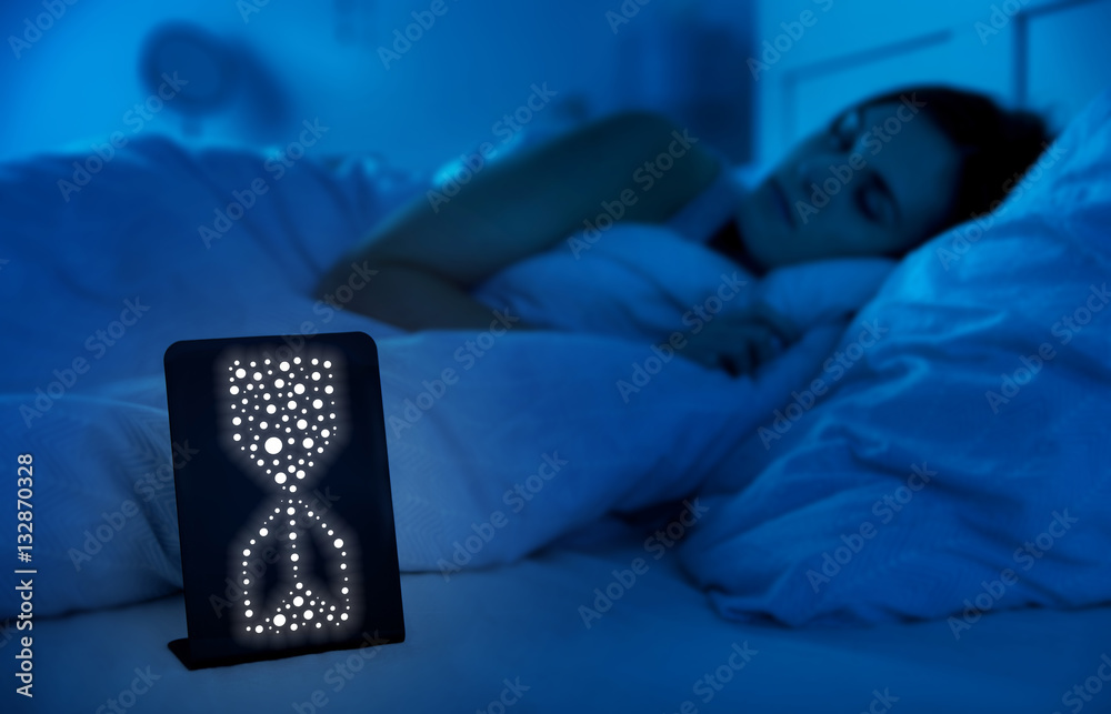 Hourglass clock measures healthy sleeping time, woman in bed