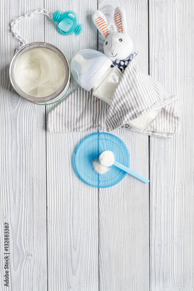 preparation of mixture baby feeding on wooden background top view