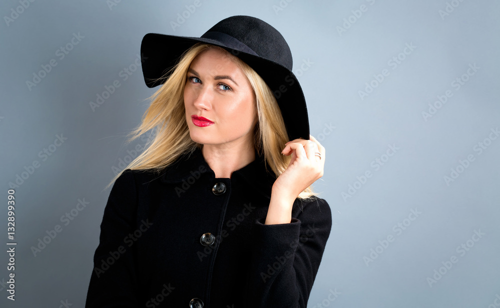 Beautiful blonde woman in a black coat