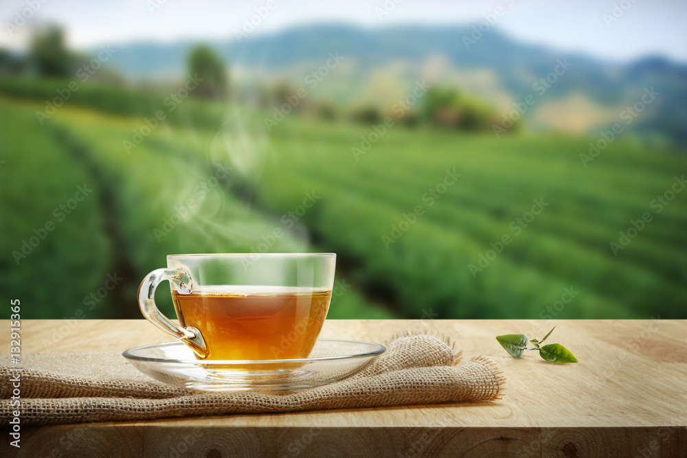 Tea cup with and tea leaf sacking on the wooden table and the te