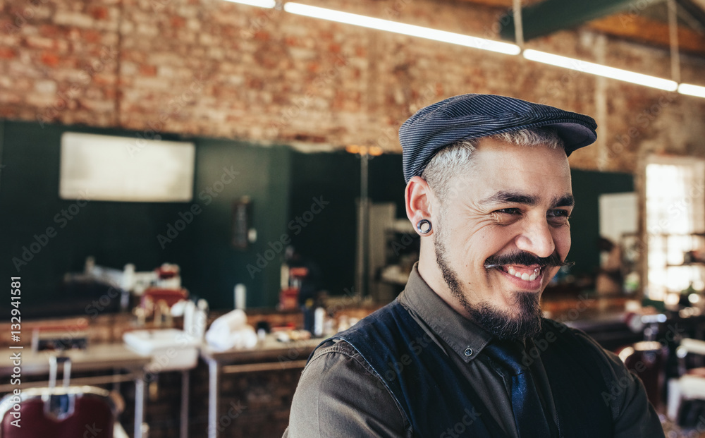 Successful male barber with cap