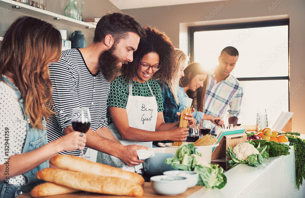 Multiracial friends cook tasteful food.