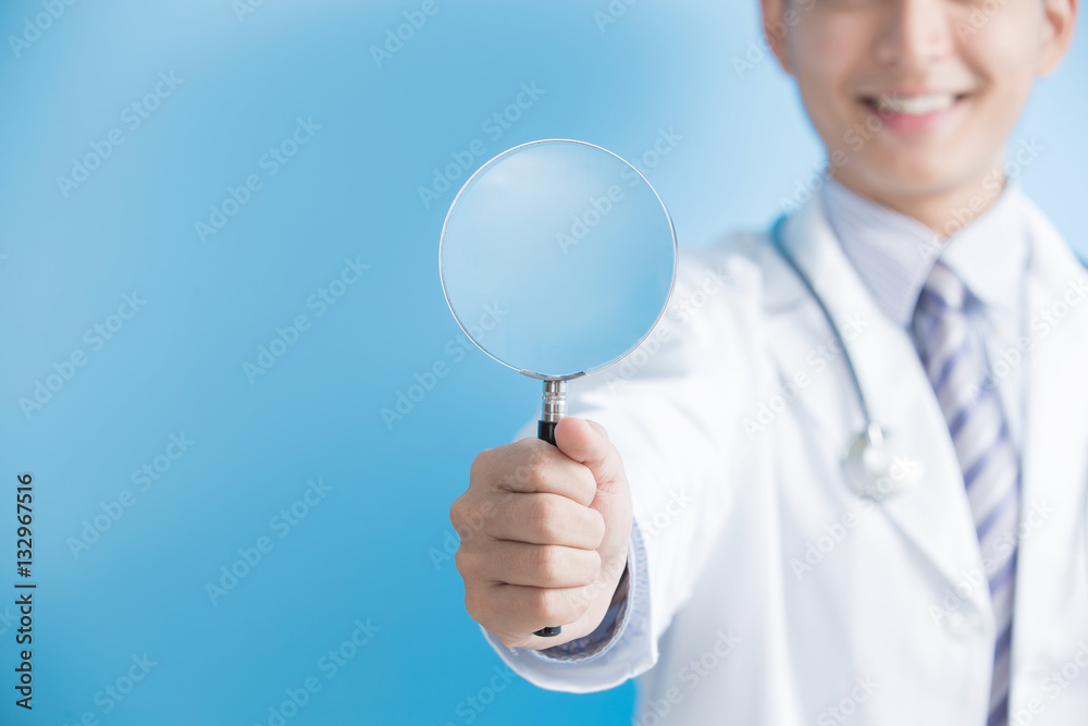 male doctor take magnifier