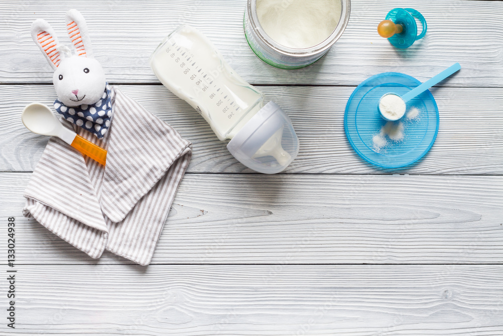 preparation of mixture baby feeding on wooden background top view