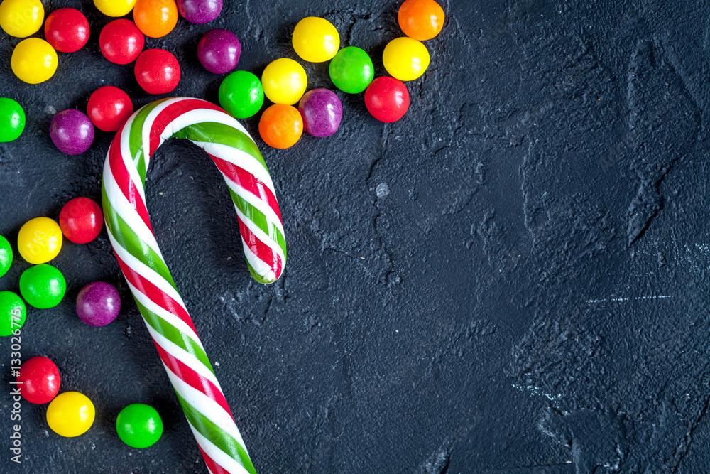 sweets and sugar candies on dark background top view