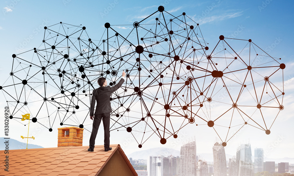 Businessman on house roof presenting networking and connection concept. Mixed media