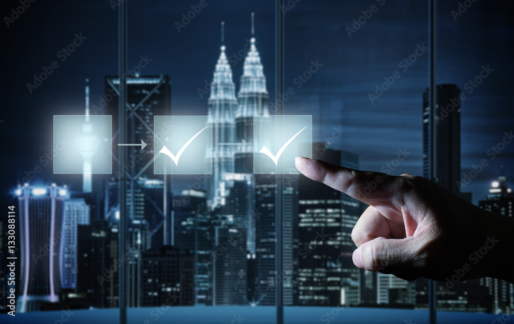 Man touching workflow illustrating management approval  flowchart with his finger on dark background