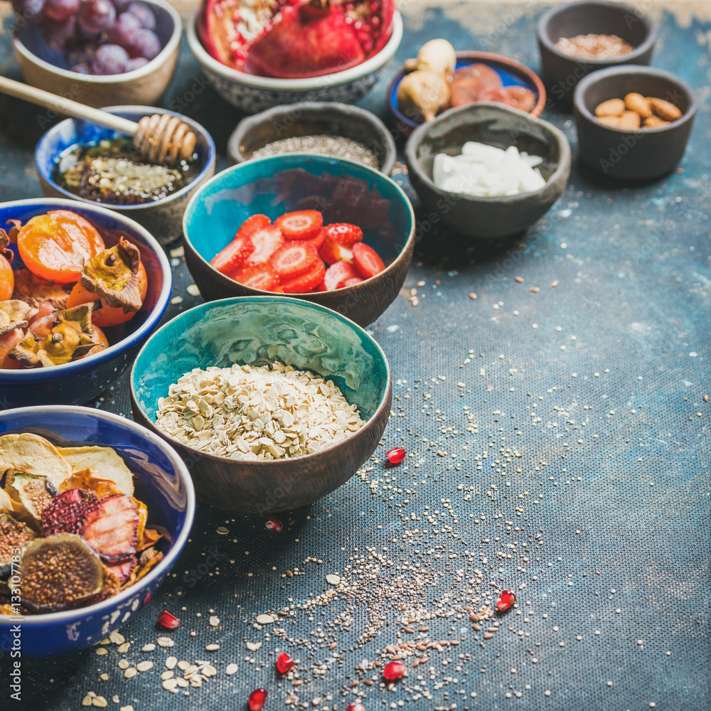 Ingredients for healthy breakfast over dark blue background, selective focus, copy space, square cro