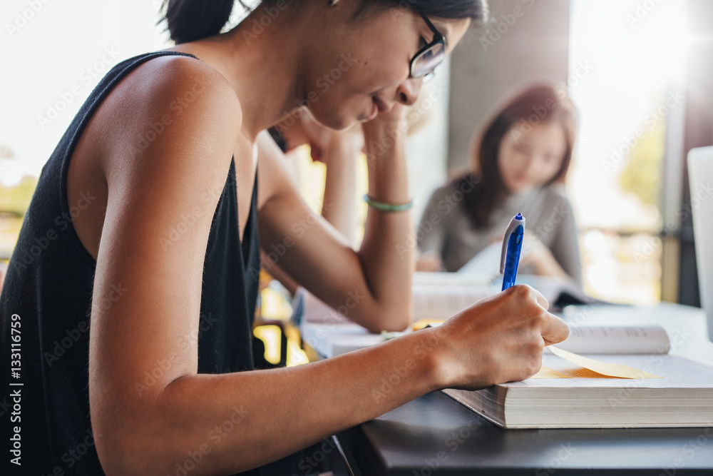 Young students studying in university library