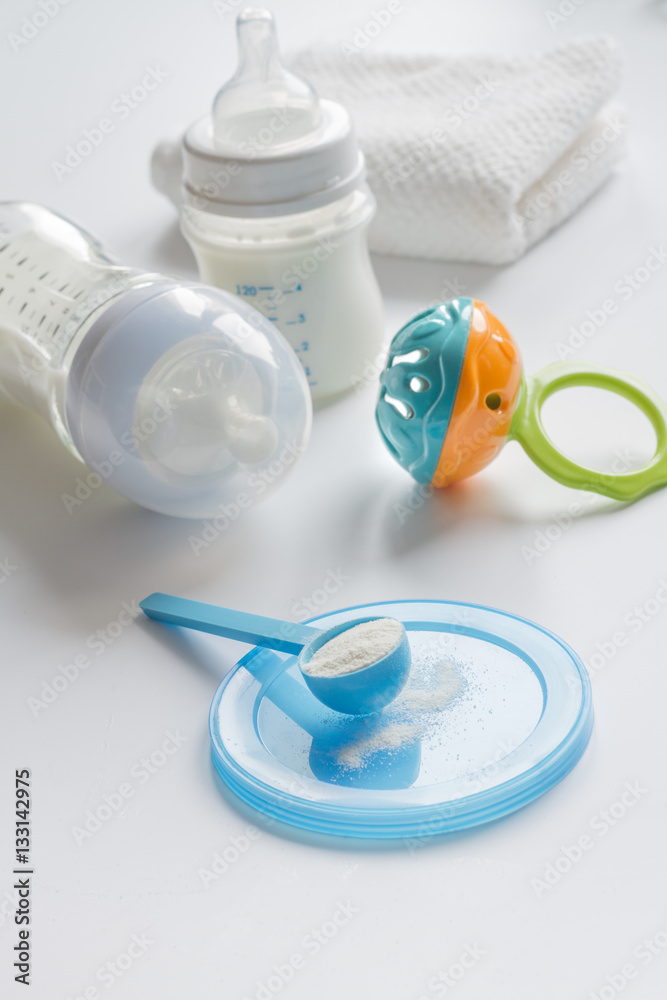 preparation of mixture baby feeding on white background