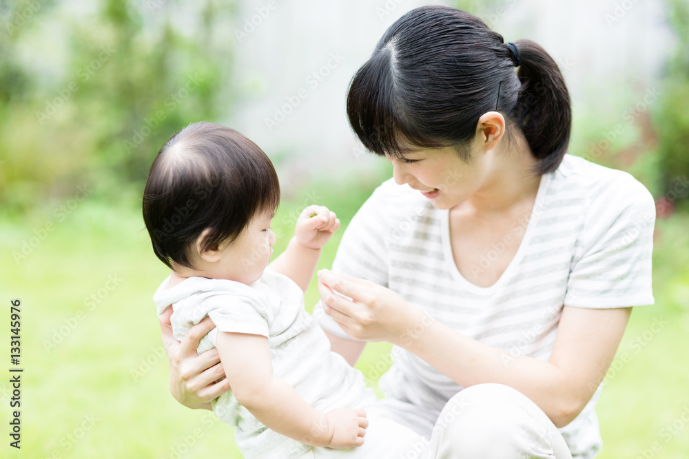 portrait of asian baby and mother relaxing