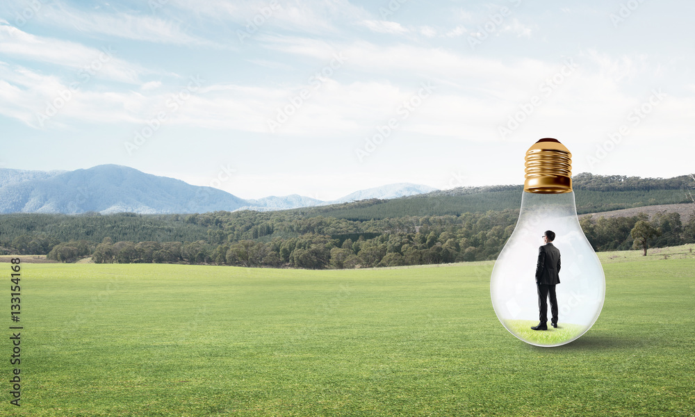 Businessman inside light bulb