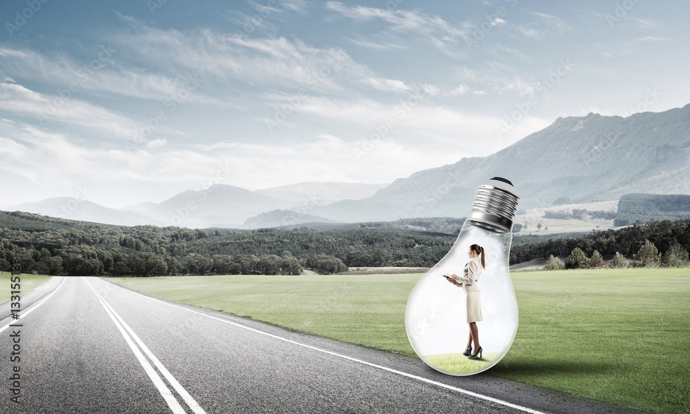 Businesswoman inside light bulb