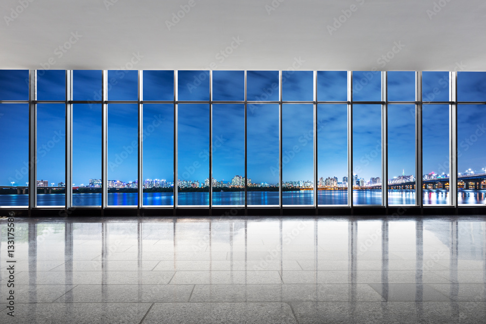 cityscape and skyline at night from window near river