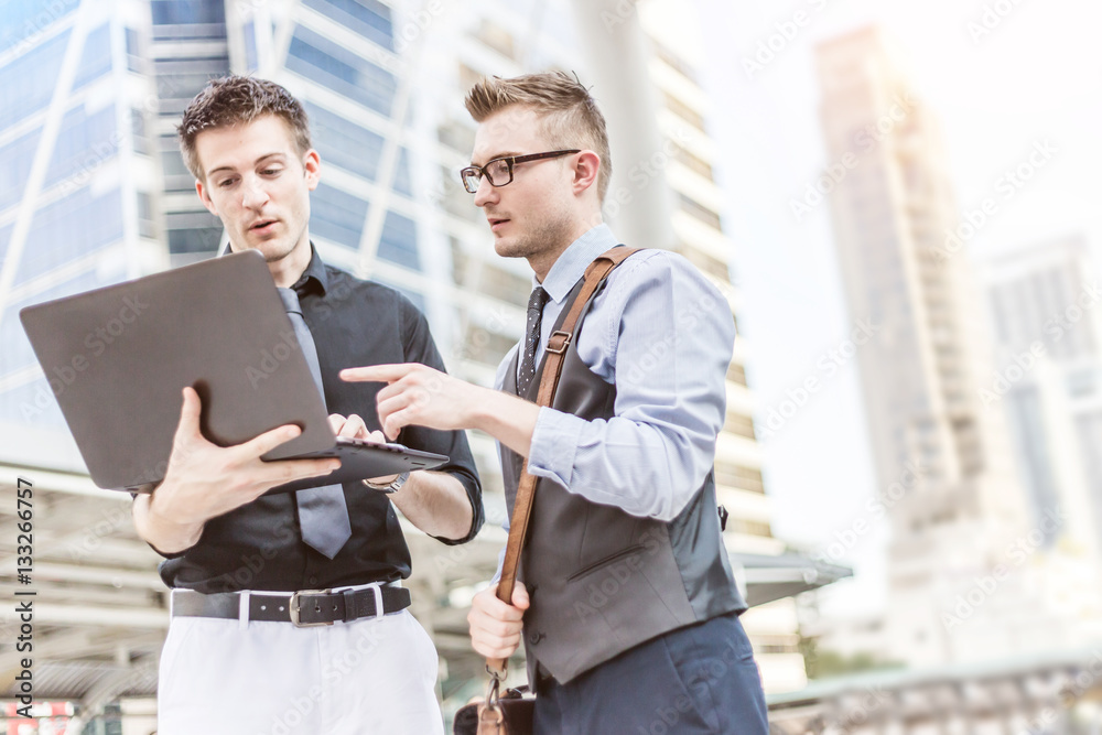 Businessman using digital laptop computer at Outside Office, Suc