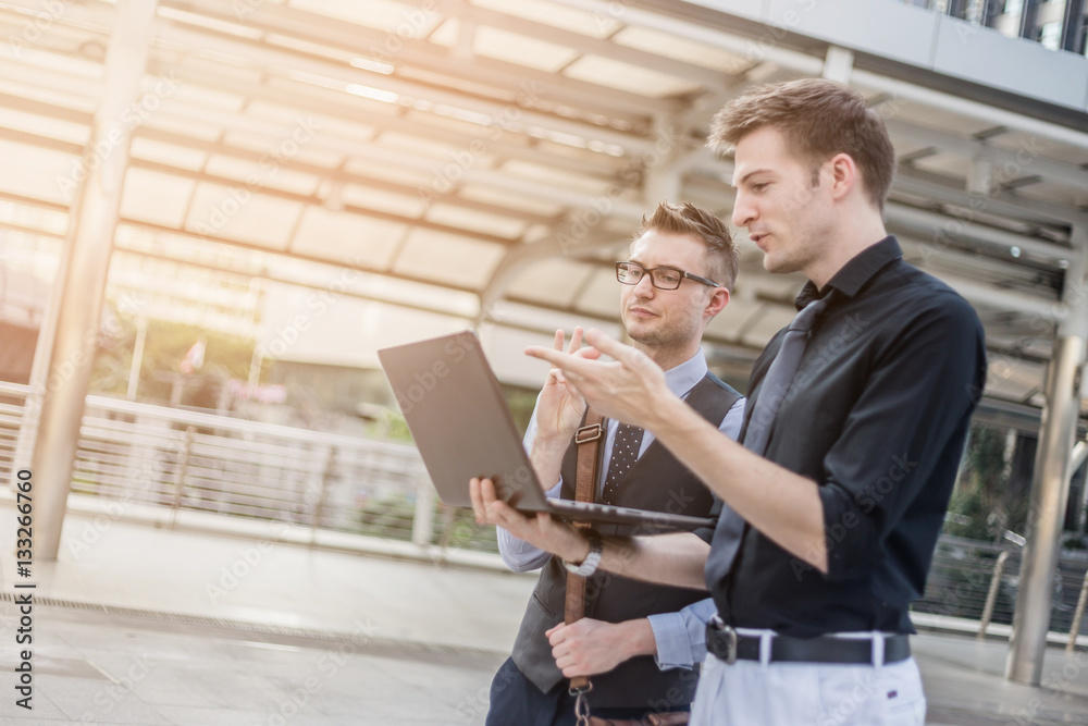 smart business man brainstorm with laptop outside office with ur