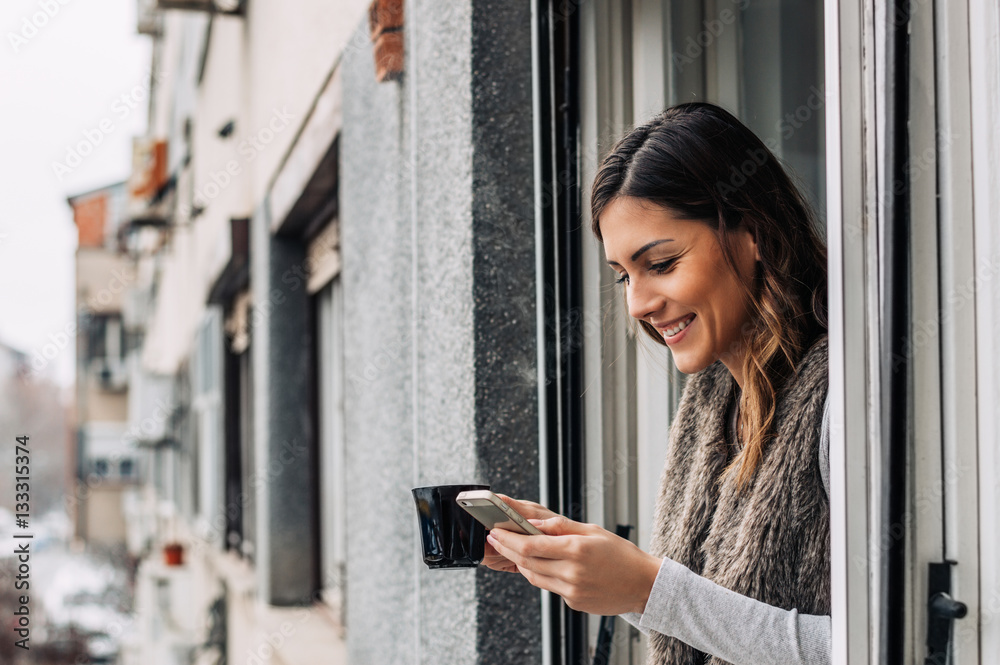 Drinking coffee, chilling, message typing. Smartphone and coffee