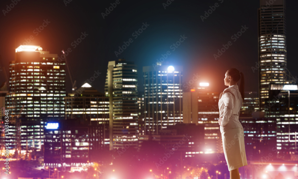 Woman looking at night city