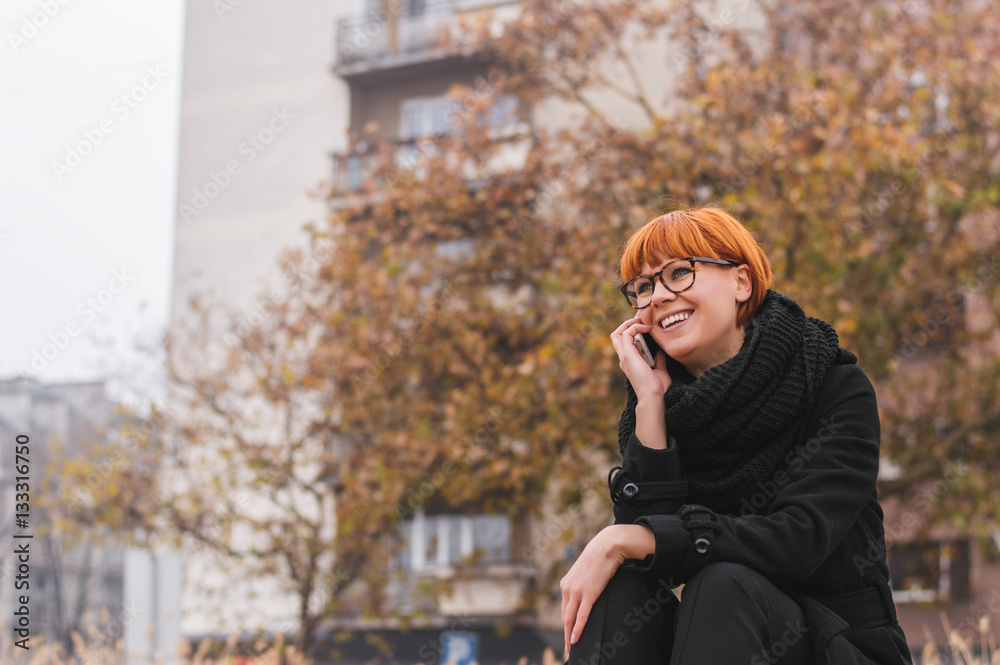 Happy young lady talking on mobile phone