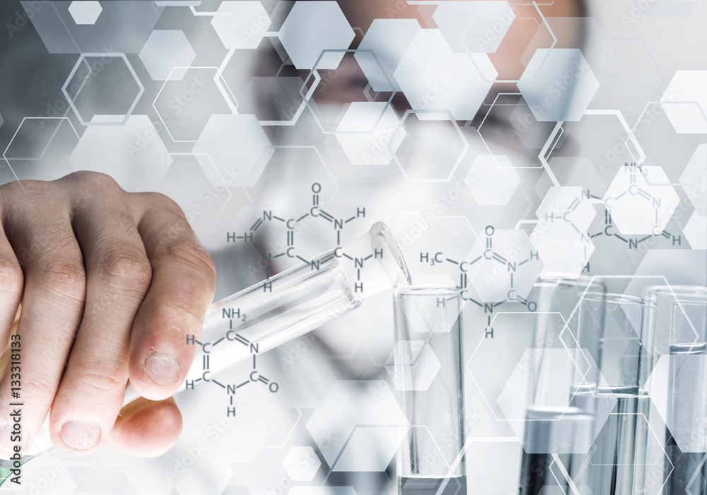 Portrait of concentrated male scientist working with reagents in laboratory