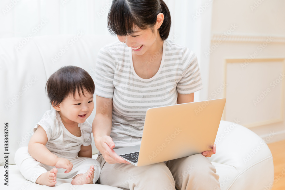 asian baby and mother using laptop