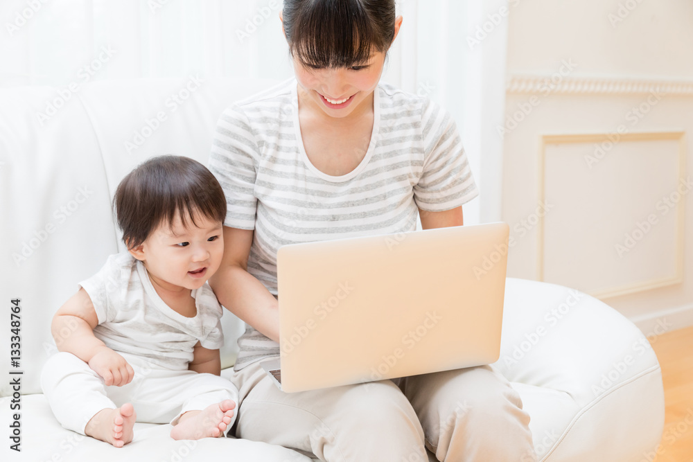 asian baby and mother using laptop