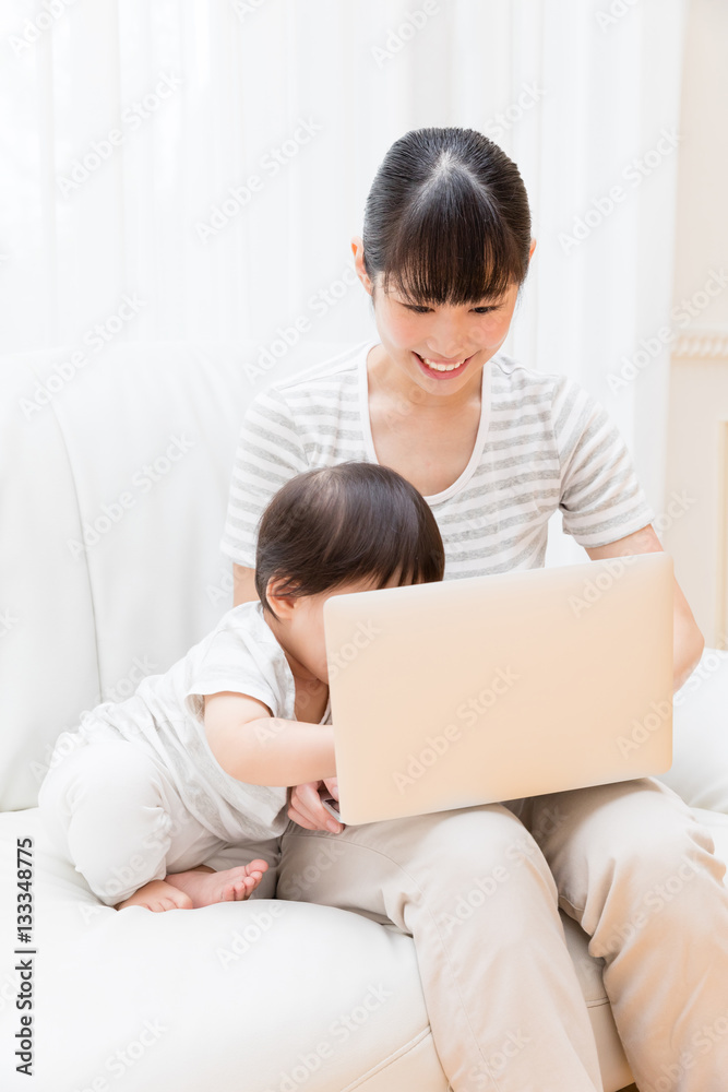 asian baby and mother using laptop