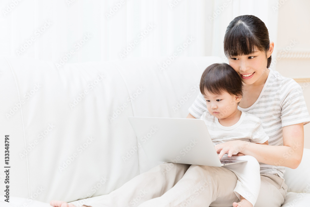 asian baby and mother using laptop