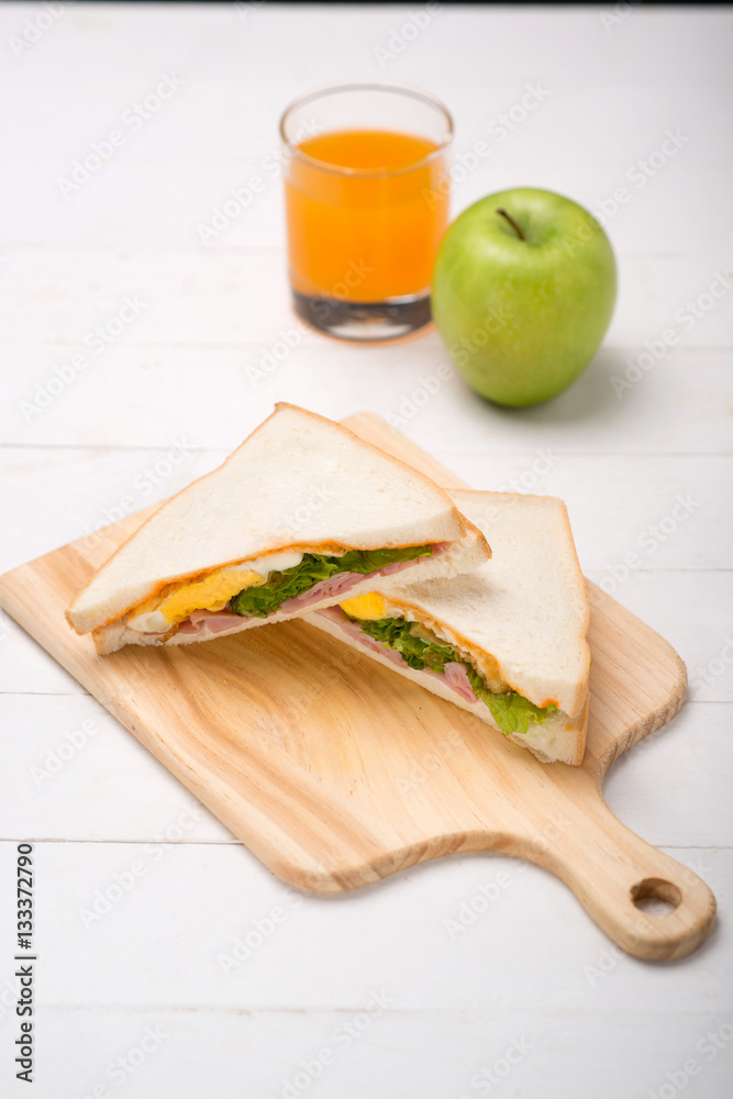 Lunch meal with milk, orange juice and sandwiches.