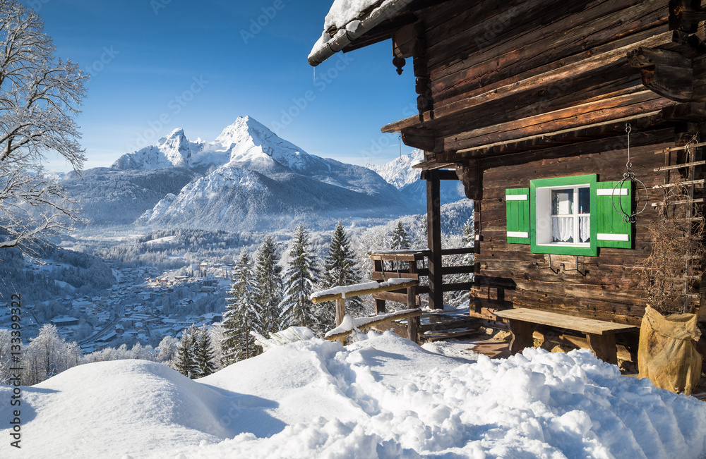 Winter wonderland in the Alps with traditional mountain chalet