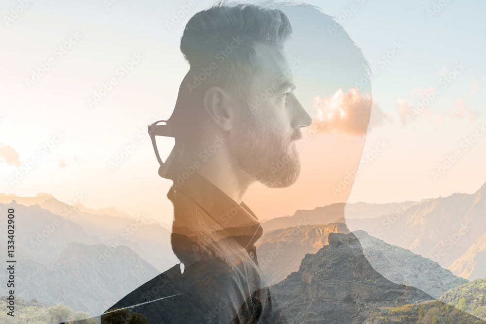 Triple exposure portrait of a businessman combinated with beautiful mountain landscape on the sunset