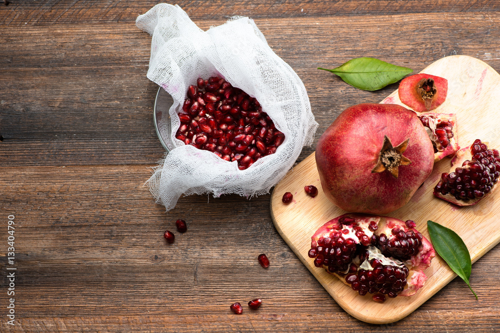 Pomegranate fruits with grains on wooden table. Top view. Make  juice.