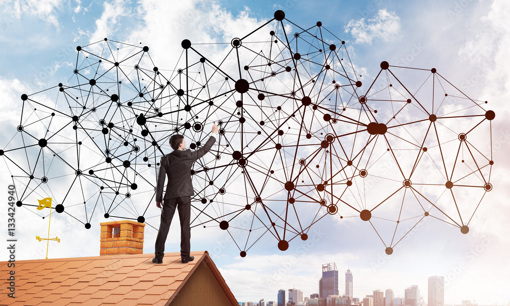 Businessman on house roof presenting networking and connection concept. Mixed media