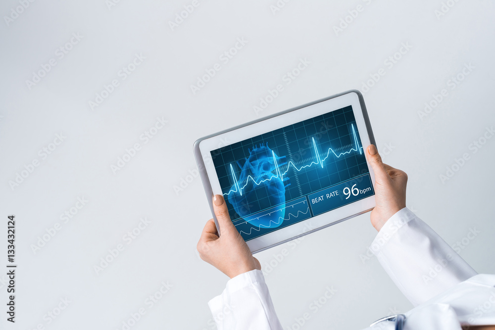 Close of female doctor hands working with tablet pc computer