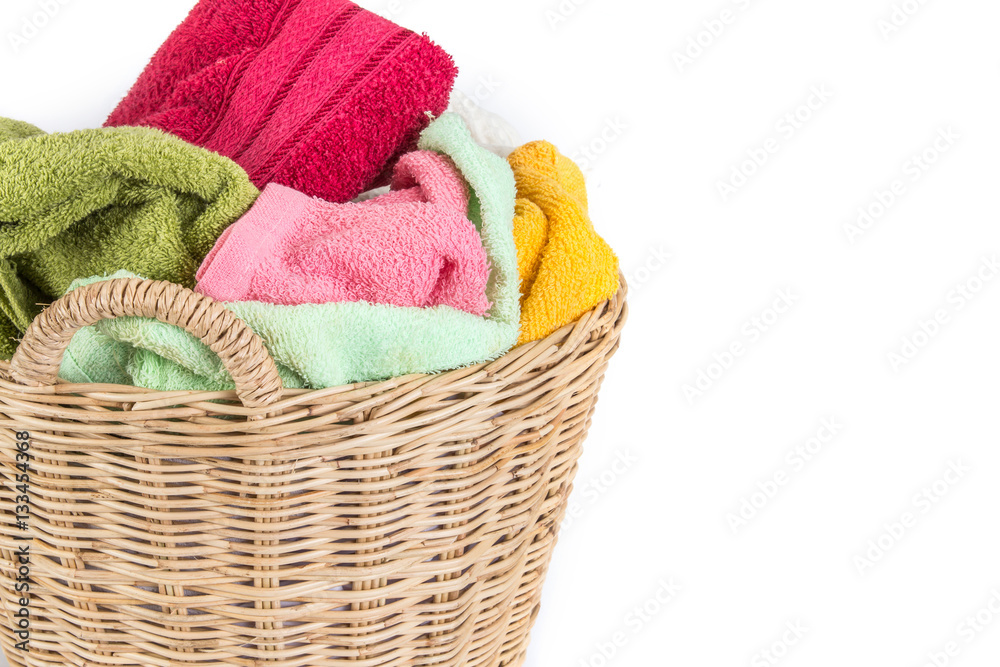 close up color mix  towel in wicker baskets on white background