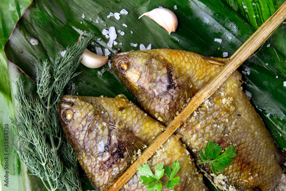 Delicious grilled fresh fish on dark stone background , healthy