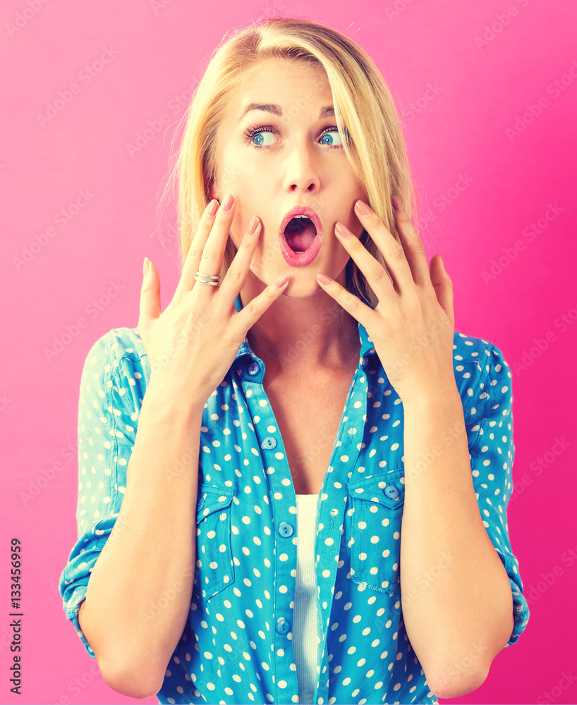 Surprised young woman posing