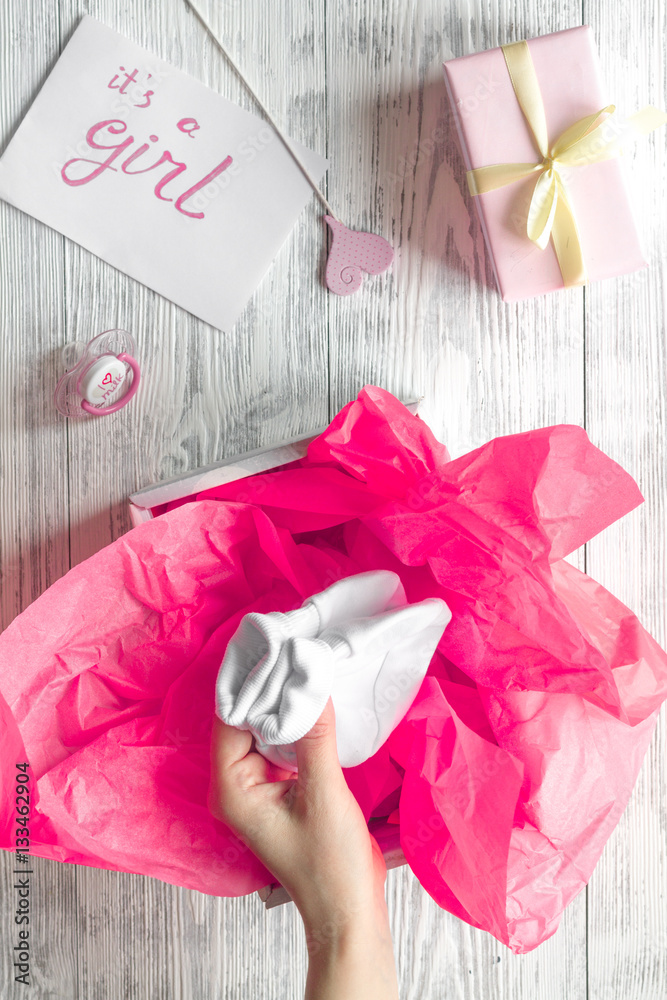 birth of girl - baby shower concept on wooden background