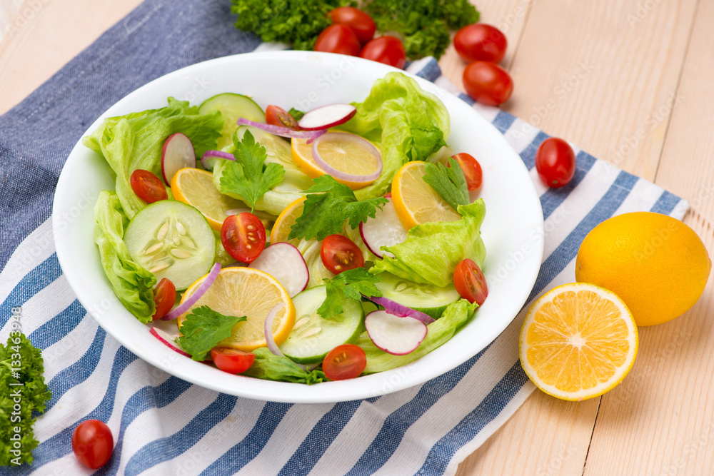 Homemade fresh green vegetable salad on table.