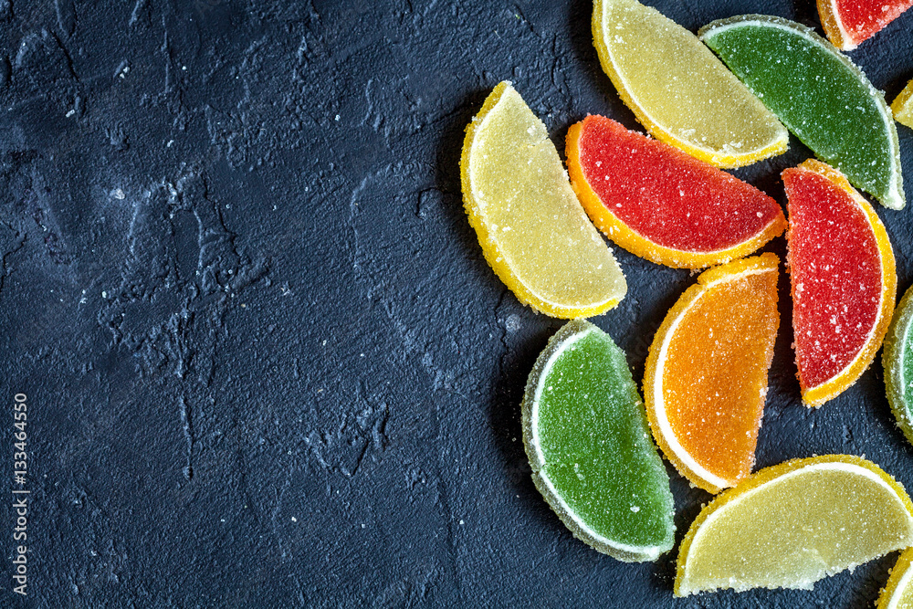 sweets and sugar candies on dark background top view