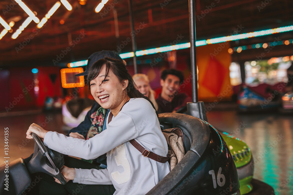 Happy young girl driving a bumper car