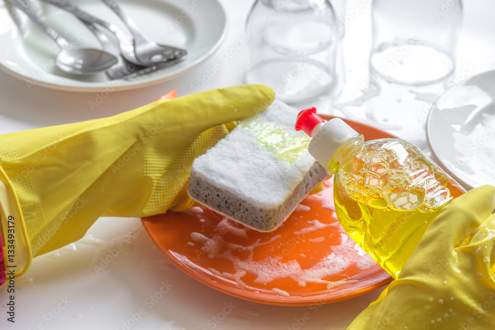 concept of woman washing dishes on white background