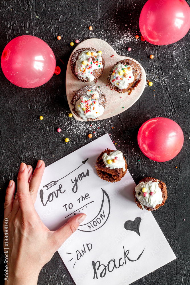 concept of Valentines Day cupcakes dark background top view