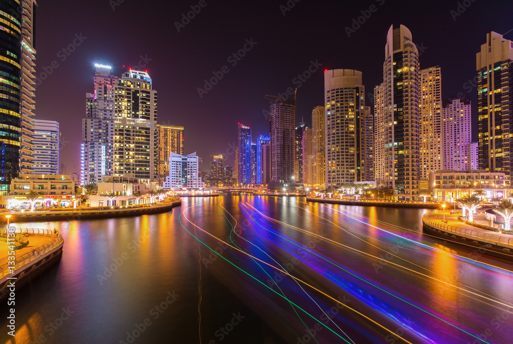 Modern skyscrapers in luxury Dubai Marina with busy promenade in the evening,Dubai,United Arab Emira