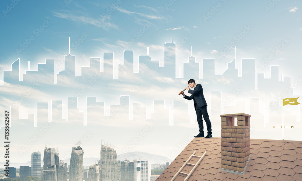 Engineer man standing on roof and looking in spyglass. Mixed med